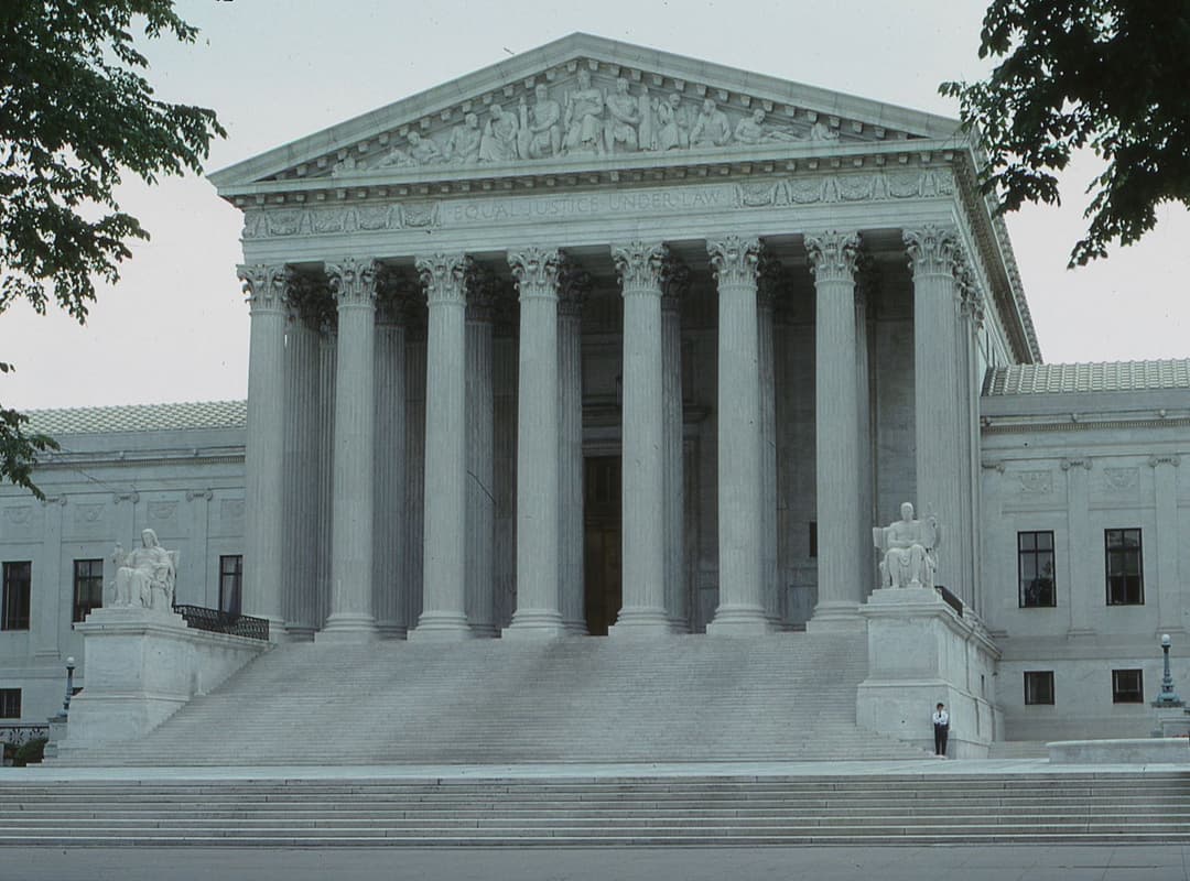 Stately courthouse columns and steps representing the justice system